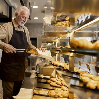 The old baker working in his bakery